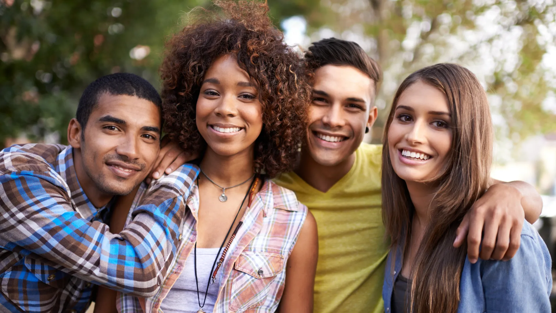 Four smiling young adults