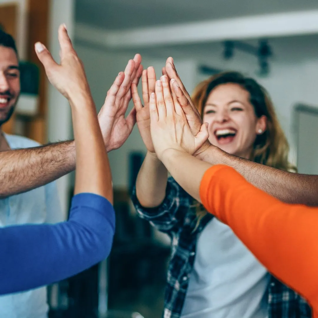 Several hands meeting for a group high-five