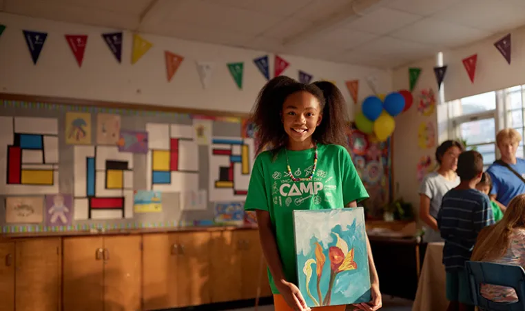 A child participating in a YMCA youth program in Canada that offers a third place for connection and socializing